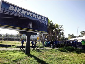 A Goodyear billboard with the Spanish word for welcome, is posted near the plant entrance in Los Guayabos, Venezuela. Workers arrived on Monday to find the plant is no longer in operation.