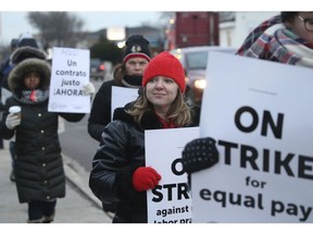 Charter school teachers including Vanessa Cerf-Nikolakakis, center, of Torres Elementary School, and other supporters walk the picket line outside the Acero's Zizumbo Elementary Charter school, Tuesday, Dec. 4, 2018, in Chicago. Hundreds of teachers have gone on strike at the Chicago charter school network, leading to canceled classes for thousands of students.