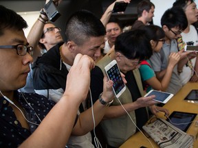 Customers look at the iPhones in Hong Kong, China. iPhone models affected by the preliminary sales ban in China are the iPhone 6S, iPhone 6S Plus, iPhone 7, iPhone 7 Plus, iPhone 8, iPhone 8 Plus and iPhone X.
