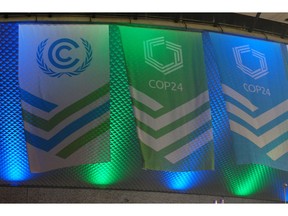 This Dec. 1, 2018 photo flags hang outside of the venue for the COP24 global climate talks in Katowice, Poland. Negotiators from around the world are meeting in Poland for talks on curbing climate change.