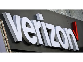 FILE - This May 2, 2017, file photo, shows Verizon corporate signage on a store in New York's Midtown. Shares of Verizon are falling before the opening bell after the company said it would take a $4.6 billion hit for what's become an expensive internet foray that's never panned out.