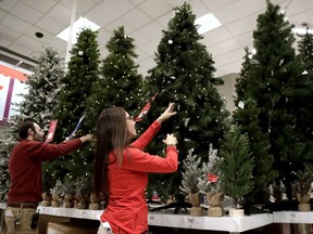 FILE- In this Friday, Nov. 16, 2018, file photo, employees work on the presentation of Christmas trees at a Target store in Bridgewater, N.J. On Thursday, Dec. 6, the Institute for Supply Management, a trade group of purchasing managers, issues its index of non-manufacturing activity for November.