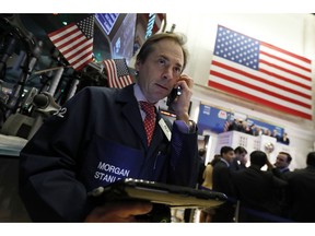 Trader Dudley Devine works on the floor of the New York Stock Exchange, Monday, Dec. 3, 2018. Stocks are opening sharply higher on Wall Street, following gains in overseas markets after the U.S. and China struck a 90-day truce in their trade dispute.