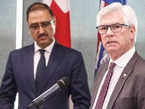 Canada's Minister of Natural Resources Amarjeet Sohi, left, and Canada's Minister of International Trade Diversification Jim Carr speak during a press conference to announce support for Canada's oil and gas sector, in Edmonton on Tuesday.