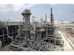 FILE - This April 4, 2009, file photo, shows a gas production facility at Ras Laffan, Qatar. The tiny, energy-rich Arab nation of Qatar announced on Monday, Dec. 3, 2018 it would withdraw from OPEC, mixing its aspirations to increase production outside of the cartel's constraints with the politics of slighting the Saudi-dominated group amid the kingdom's boycott of Doha.