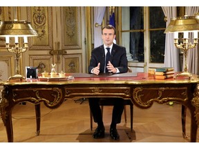 French President Emmanuel Macron poses before a special address to the nation, his first public comments after four weeks of nationwide 'yellow vest' protests, at the Elysee Palace, in Paris, Monday, Dec. 10, 2018. Facing exceptional protests, French President Emmanuel Macron is promising to speed up tax relief for struggling workers and to scrap a tax hike for retirees.