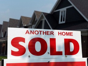 A for sale sign displays a sold home in a housing development in Ottawa.