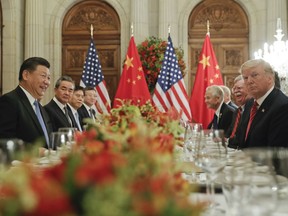 In this Dec. 1, 2018, photo, President Donald Trump, second from right, meets with China's President Xi Jinping, second from left, during their bilateral meeting at the G20 Summit, in Buenos Aires, Argentina. China promised Wednesday, Dec. 5, 2018, to carry out a tariff cease-fire with Washington but gave no details that might help dispel confusion about what Presidents Xi and Trump agreed to in Argentina.