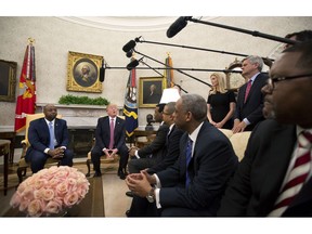 FILE - In this Feb. 14, 2018, file photo, President Donald Trump, with Sen. Tim Scott, R-S.C., left, Ivanka Trump, top second from right, and Steve Case, top right, participate in a working session regarding the opportunity zones provided by tax reform in the Oval Office of the White House in Washington. An Associated Press investigation found Trump's daughter and son-in law stand to benefit from a program they pushed that offers massive tax breaks to developers who invest in downtrodden American areas.