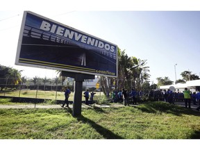 A Goodyear billboard emblazoned with the Spanish word for welcome, is posted near a plant entrance company where workers arrived to find the plant is no longer in operation, in Los Guayabos, Venezuela, Monday, Dec. 10, 2018. U.S. tire company Goodyear announced it will no longer continue production in Venezuela as economic conditions in the South American nation continue to deteriorate.