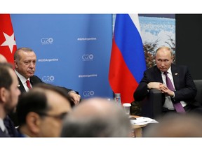 Russian President Vladimir Putin, right, and Turkey's President Recep Tayyip Erdogan, attend talks at the G20 summit in Buenos Aires, Argentina, Saturday, Dec. 1, 2018.
