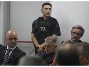 Former Ford Motor Co. executive Hector Sibilla, center, who is charged with crimes against humanity for allegedly targeting Argentine union workers for kidnapping and torture after the country's 1976 military coup, awaits sentencing in Buenos Aires, Argentina, Tuesday, Dec. 11, 2018.