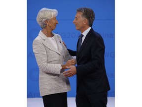 International Monetary Fund Managing Director Christine Lagarde, left, is welcomed by Argentina's President Mauricio Macri as she arrives for the G20 Leader's Summit inside the Costa Salguero Center in Buenos Aires, Argentina, Nov. 30, 2018.