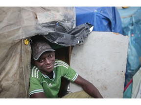 Wazzizi, a sub-Saharan migrant from Guinea, sits outside the tent where he lives at at Ouled Ziane camp in Casablanca, Morocco, Thursday, Dec. 6, 2018. As Morocco prepares to host the signing of a landmark global migration agreement next week, hundreds of migrants are languishing in a Casablanca camp rife with hunger, misery and unsanitary conditions. These sub-Saharan Africans who dream of going to Europe are a symbol of the problems world dignitaries are trying to address with the U.N.'s first migration compact.