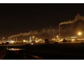 A night view of Sasol Plant, a plant that produces petrol and diesel from coal, in Sasolburg, South Africa, Tuesday, Dec. 4, 2018. The two-week  U.N. climate meeting in Poland is intended to finalize details of the 2015 Paris accord on keeping average global temperature increases well below 2 degrees Celsius (3.6 Fahrenheit).