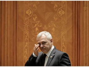 FILE - In this Thursday, Dec. 20, 2018 file photo, Head of the Ruling Social Democratic Party, Liviu Dragnea, wipes his eyes as he joins a parliament session during a no-confidence vote initiated by opposition parties in Bucharest, Romania. Dragnea who has clashed with the European Union over the government's approach to fighting high-level corruption, is expected to miss events marking Romania's six-month presidency of the bloc.