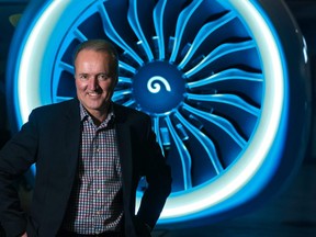 WestJet CEO Ed Sims stands in front of one of the efficient and quieter engines on a new Boeing 737 Max 8 at WestJet's Calgary hanger on Thursday December 6, 2018. Gavin Young/Postmedia