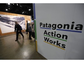 In this Wednesday, Jan. 30, 2019, photograph, a sign stands at the entrance to the Patagonia exhibit at the Outdoor Retailer & Snow Show in the Colorado convention Center in Denver. Major players in the outdoor industry jumped into the political fight over national monuments two years ago and now have added climate change and sustainable manufacturing to their portfolio.