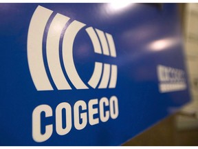 A Cogeco sign hangs at the company's annual general meeting in Montreal, Tuesday, January 14, 2014. Cogeco Inc. says an acquisition by its cable and internet segment pushed up first-quarter revenue, but profit was down due to higher costs associated with integrating and restructuring the business.