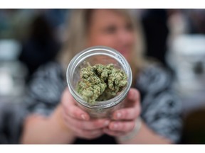 A vendor displays marijuana for sale during the 4-20 annual marijuana celebration, in Vancouver, B.C., on Friday April 20, 2018. The Ontario Cannabis Retail Corporation/OCS is seeking a courier company to offer same-day pot delivery.