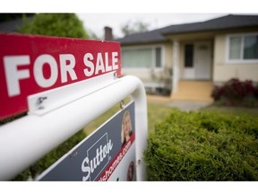 A real estate sign is pictured in Vancouver, B.C., Tuesday, June 12, 2018. The Canadian Real Estate Association says real estate transactions declined in about 60 per cent of all markets across the country in December.The organization says national home sales fell 2.5 per cent from November to December.THE CANADIAN PRESS Jonathan Hayward