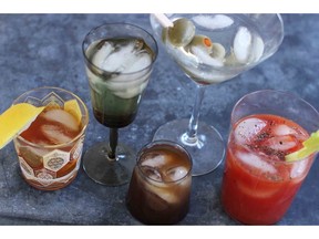 This March 23, 2015 photo shows mixed cocktails, from left, an old fashioned, a vodka gimlet, a Bull Shot, a dry martini and a bloody mary. The federal government is asking Canadians how they like their vodka. The Canadian Food Inspection Agency has opened consultations on whether to redefine the clear, neutral spirit and open interprovincial trade for innovative craft distillers who want to try something new.