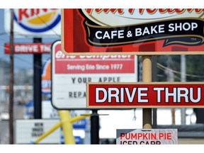 In this Tuesday, Aug. 26, 2014 file photo, fast food restaurant signs line Peach Street in Erie, Pa. During a slow day at fast-food restaurants it's typical for managers to cut employees' scheduled shifts short, sending some workers home after several hours.