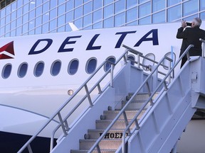 A employee takes a photo while Delta unveils the new A220 aircraft while celebrating the 10-year anniversary of merging with Northwest at the Delta Air Lines TechOps on Monday, Oct. 29, 2018, in Atlanta.