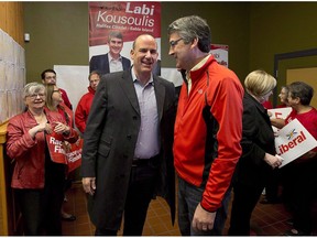 Nova Scotia Liberal Leader Stephen McNeil, right, chats with Labi Kousoulis, in Halifax on Monday, Oct. 7, 2013. Nova Scotia's minimum wage is going up, with the province's labour minister Kousoulis saying the pay hike will help workers and their families.