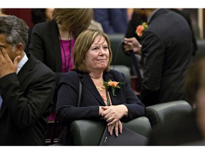 Minister of Energy Marg McCuaig-Boyd waits for the speech from the throne to start in Edmonton, Alta., on June 15, 2015. Alberta Energy Minister Marg McCuaig-Boyd says the province is leaving its oil curtailment levels at 325,000 barrels per day for now despite discounts for western Canadian crude that have narrowed to three-and-a-half-year lows.