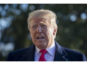 President Donald Trump speaks on the South Lawn of the White House while walking to Marine One, Sunday, Jan. 6, 2019, in Washington. Trump is en route to Camp David.