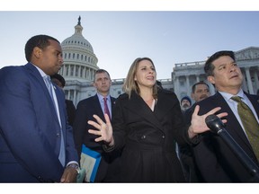 Rep. Joe Neguse, D-Colo., left, Rep. Sean Casten, D-Ill., Rep. Katie Hill, D-Calif., Rep. TJ Cox, D-Calif., and other freshmen members of the House of Representatives speak about the government shutdown in front of the U.S. Senate on Capitol Hill, Tuesday, Jan. 15, 2019 in Washington.