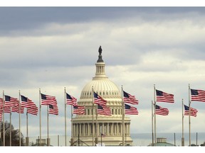 Flags fly in front of the U.S. Capitol in Washington, Tuesday morning, Jan. 1, 2019, as a partial government shutdown stretches into its third week.  A high-stakes move to reopen the government will be the first big battle between Nancy Pelosi and President Donald Trump as Democrats come into control of the House.