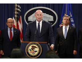 Acting Attorney General Matt Whitaker, center, with Commerce Secretary Wilbur Ross, left, and FBI Director Christopher Wray speak Monday, Jan. 28, 2019, at the Justice Department in Washington. The Justice Department unsealed criminal charges Monday against Chinese tech giant Huawei, two of its subsidiaries and a top executive, who are accused of misleading banks about the company's business and violating U.S. sanctions.