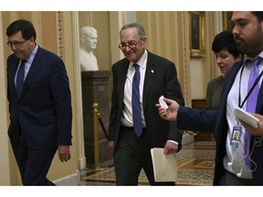 Senate Minority Leader Sen. Chuck Schumer of N.Y., center, talks with reporters as he walks on Capitol Hill in Washington, Wednesday, Jan. 2, 2019, after returning from a meeting with President Donald Trump at the White House.