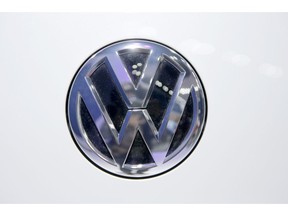 In this Wednesday, Feb. 3, 2016, photo, Volkswagen logo is seen on a vehicle displayed at the Auto Expo in Greater Noida, near New Delhi, India. The Volkswagen Group says that it will deposit a fine of 1 billion rupees ($14.2 million) imposed by India's green panel for installing software that allegedly cheated pollution testing devices.