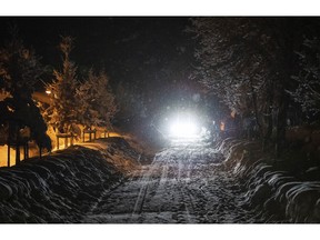 A car drives on a snow covered street at the Bavarian city Berchtesgaden, Germany, Friday, Jan 11, 2018, after Austria and southern Germany were hit by heavy snowfall.