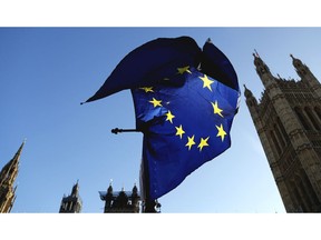 A European flag flies opposite the Houses of Parliament as Pro-European demonstrators protest in London, Monday, Jan. 14, 2019.  British Prime Minister Theresa May planned to tell lawmakers Monday that she has received further assurances about her Brexit deal from the European Union, in a last-ditch attempt to stave off a crushing defeat for the unpopular agreement.