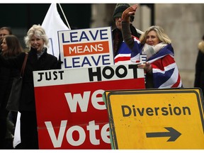 Leavers display banners opposite the Houses of Parliament to protest against the Brexit-Deal in London, Monday, Jan. 14, 2019. Britain's Prime Minister Theresa May is struggling to win support for her Brexit deal in Parliament. Lawmakers are due to vote on the agreement Tuesday, and all signs suggest they will reject it, adding uncertainty to Brexit less than three months before Britain is due to leave the EU on March 29.