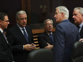 European Union chief Brexit negotiator Michel Barnier, second right, talks to European Commissioners prior to the start of the weekly College of Commissioners meeting at EU headquarters in Brussels, Wednesday, Jan. 30, 2019. The European Union's Brexit negotiator says the EU stands united in defence of its divorce deal with Britain, after Prime Minister Theresa won a parliamentary mandate to reopen the agreement.