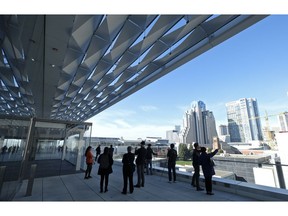 People stand on one of the new terraces and look out at the skyline during the Moscone Center expansion opening Thursday, Jan. 3, 2019, in San Francisco. Completion of the $550 million expansion was celebrated by city officials, tourism industry leaders and neighborhood stakeholders. Mayor London Breed said that the downtown structure will better meet the needs of tourism even as the city struggles with homelessness.