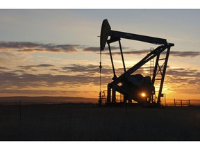 FILE - This Nov. 6, 2013 file photo shows a Whiting Petroleum Co. pump jack pulls crude oil from the Bakken region of the Northern Plains near Bainville, Mont. As the Trump administration rolls back environmental and safety rules for the U.S. energy sector, government projections show billions of dollars in savings reaped by companies will come at a steep cost: increased premature deaths and illnesses from air pollution, a jump in climate-warming emissions and more derailments of trains carrying explosive fuels.