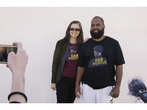 In this Nov. 30, 2018, photo provided by PRX, Nigel Poor, left, and Earlonne Woods, podcast co-hosts and co-producers for "Ear Hustle," stand outside San Quentin State Prison on Woods' release day in San Quentin, Calif. Woods, 47, was released from the prison after California Gov. Jerry Brown commuted his 31-years-to-life sentence for attempted armed robbery. Brown cited Woods' leadership in helping other inmates and his work at "Ear Hustle," a podcast he co-hosts and co-produces that documents everyday life inside the prison.