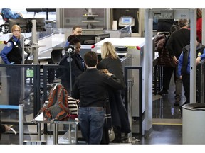 Transportation Security Administration officers work at a checkpoint at O'Hare airport in Chicago, Saturday, Jan. 5, 2019. The TSA acknowledged an increase in the number of its employees calling off work during the partial government shutdown.