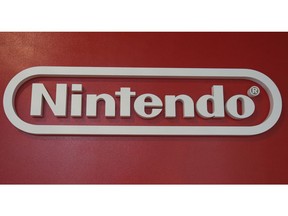 In this June 19, 2018, photo, a logo of Nintendo hangs at Panasonic center in Tokyo. Nintendo, the Japanese video game maker behind the Super Mario and Pokemon franchises, is reporting a 25 percent jump in fiscal third-quarter profit, boosted by the popularity of games for its Switch console.