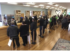 FILE - In this Jan. 4, 2018, file photo, customers line up inside the Harborside cannabis dispensary in Oakland, Calif. Gavin Newsom's new budget is a figure that says a lot about California's shaky legal marijuana market: the state is expecting a lot less cash coming in from cannabis taxes.
