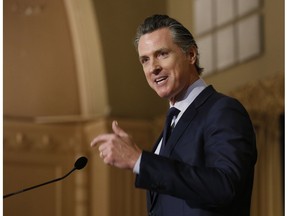 FILE - In This Jan. 17, 2019, file photo, California Gov. Gavin Newsom speaks at the California Legislative Black Caucus Martin Luther King Jr., Breakfast in Sacramento, Calif. Newsom's administration is using a new law for the first time in an attempt to force Southern California's self-styled "Surf City USA" to meet housing goals. The administration on Friday, Jan. 25, 2019, said it is suing Huntington Beach under the law that took effect Jan. 1. The measure was passed in 2017 as part of a package of bills intended to address the state's severe housing shortage and homelessness problem.