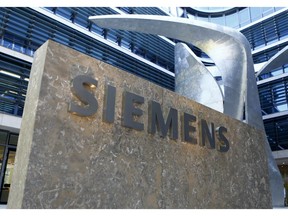 FILE - This June 24, 2016 file photo, showing the logo of German industrial conglomerate Siemens at their headquarters in Munich, Germany.  Siemens AG, maker of power generation and transmission equipment, as well as trains and medical imaging devices, reports on Wednesday Jan. 30, 2019, its earnings for the most recent quarter.