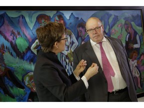 German Economy Minister, Peter Altmaier, right, talks with German Federal Bank Vice President Claudia Buch prior to the weekly cabinet meeting of the German government at the chancellery in Berlin, Wednesday, Jan. 30, 2019.