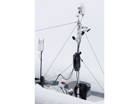 An armed Swiss police officer stands under a security camera system on the roof of the congress center where the annual meeting of the World Economic Forum, WEF, take place in in Davos, Monday, Jan. 21, 2019.